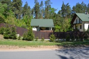 een huis met een hek voor een huis bij Domek w Sajenku in Augustów