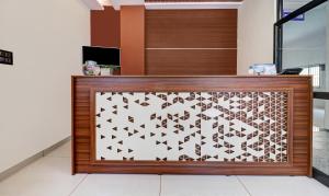 a lobby with a laser cut sign on the wall at Itsy Hotels NRM Residency in Mysore