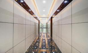 a long corridor of mirrors in a building at Itsy Hotels NRM Residency in Mysore