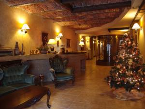 een woonkamer met een kerstboom in een lobby bij Hotel Bella Muzica in Braşov