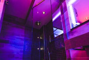 a bathroom with purple lights in a room at Church Suites by The Cranleigh Boutique in Bowness-on-Windermere