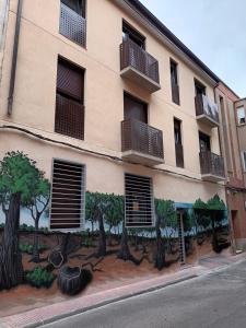 a building with trees painted on the side of it at La Casona del Eboni in Alcalá de Henares