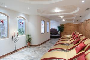 a row of chairs in a room with windows at Hotel Dornauhof in Finkenberg