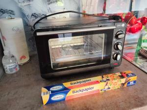 a toaster oven sitting on a counter next to a box at Ferienwohnung in Leckwitz bei Nünchritz Wacker, Elbradweg in Nünchritz