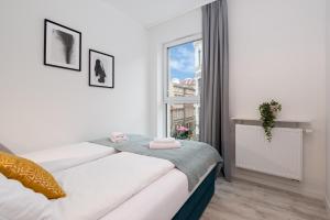 Una cama o camas en una habitación de Apartament Prestige Centrum 3