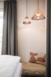 a bedroom with two pendant lights and a bed at apartments55 in Bressanone