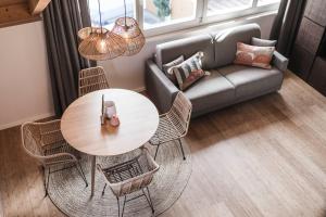 a living room with a couch and a table and chairs at apartments55 in Bressanone