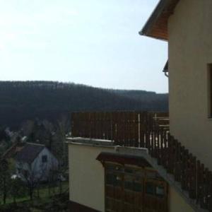 a balcony of a building with a mountain in the background at Szigeti B&B in Bogács