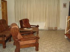 a living room with a couch and chairs and a table at Szigeti B&B in Bogács