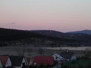 a view of a town with a river and houses at Szigeti B&B in Bogács