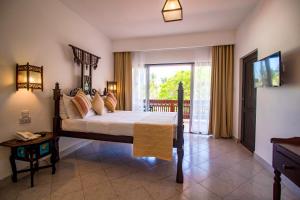 A bed or beds in a room at Bamburi Beach Hotel