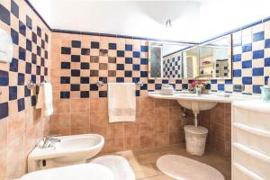 a bathroom with a toilet and a sink at Sardinia Home in Palau