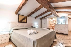 a bedroom with a bed with two pillows on it at Sardinia Home in Palau