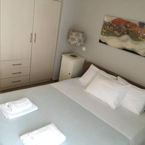 - une chambre avec un lit blanc et 2 oreillers blancs dans l'établissement Aloe Apartment in Epidaurus, à Ancient Epidavros