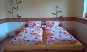 A bed or beds in a room at Penzion Areal Zamma