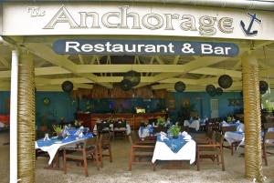 a restaurant with tables and chairs and a sign that reads the americanace restaurant at Sunset Resort in Rarotonga