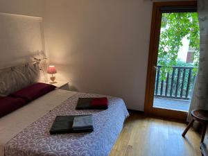 a bedroom with a bed and a window with a balcony at Chalet Blanc "Le Flocon" in Courmayeur