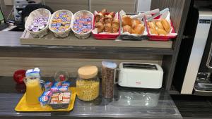 a shelf with various foods and other food items at Hotel du Triangle in Talange