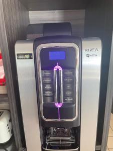 a klezmer electronic device sitting on top of a refrigerator at Hotel du Triangle in Talange