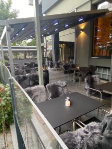 a restaurant with tables and chairs on a balcony at OLÉ Hotel in Hamburg