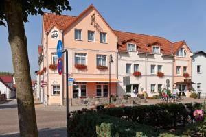 a large building in a town with a street at Hotel Für Dich in Waren