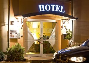 a hotel sign on the front of a building at Hotel Für Dich in Waren