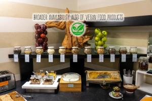 a bakery with a display of different types of food at Hotel Ancora in Verbania