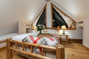 a bedroom with a wooden bed and two windows at Moberly Lodge in Golden