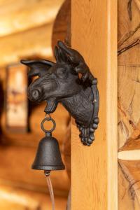 a bell with a horse head hanging on a wall at Moberly Lodge in Golden