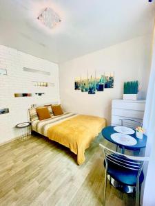 a bedroom with a bed and a table at Smart Studio New York 2 in Irpin'