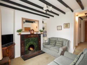 a living room with a couch and a fireplace at Pen Dinas in Bangor