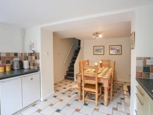 a kitchen and dining room with a table and chairs at Pen Dinas in Bangor