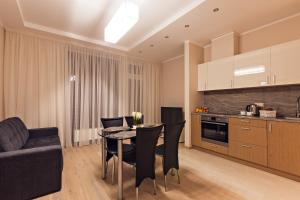 - une cuisine et une salle à manger avec une table et des chaises dans l'établissement Sonia Apartments, à Jurmala