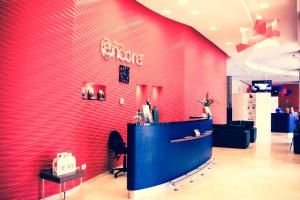 a store with a red wall with a sign on it at Ramada Encore By Wyndham Tangier in Tangier