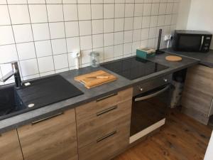 a kitchen with a counter top with a cutting board at Le Godefroy de Bouillon in Boulogne-sur-Mer