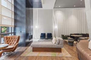 a living room with a couch and a table at Placemakr Marymount Ballston in Arlington