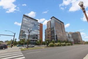 a street with two tall buildings on a city street at Placemakr Marymount Ballston in Arlington