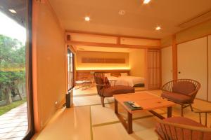 Cette chambre dispose d'un balcon avec un lit, une table et des chaises. dans l'établissement Japanese Ryokan Seryo, à Kyoto