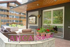 a patio with chairs and plants on a building at Hotel Arca Solebad & Spa in Zermatt