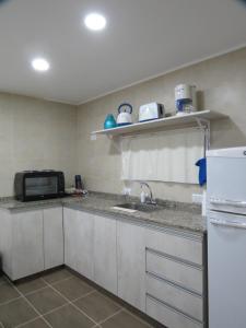 cocina con fregadero y microondas en Cabaña La Verdicchio Urbanización Cristobal Lote 2, en Valle Grande