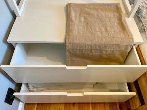 an open drawer with a box sitting on top of it at Apartament Odrzanka in Gryfino