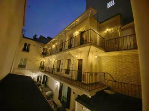 ein Gebäude mit einem Balkon mit Beleuchtung in der Unterkunft Hotel Aviatic in Paris