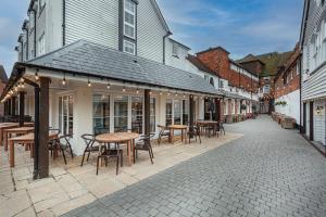 a street with tables and chairs and a building at The White Horse Hotel, Romsey, Hampshire in Romsey