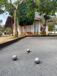 three balls on the ground in front of a building at Roça Vale dos Prazeres in São Tomé