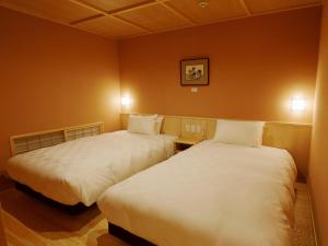 Ліжко або ліжка в номері Hotel Shikinoyakata Hakone Ashinoko