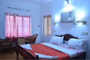 Tempat tidur dalam kamar di Sithara Homestay Fort Cochin