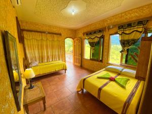 a bedroom with two beds and a window at El Mirador de Tansu in Lanquín