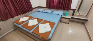 A bed or beds in a room at Sai Raghunandan Guest House