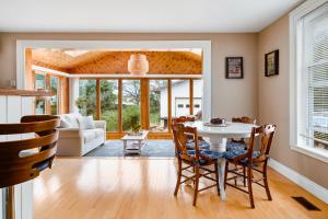 a dining room with a white table and chairs at Sunroom on Maple in Picton