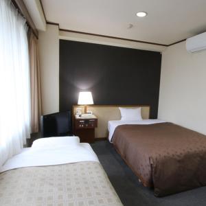 Hotel Aston Hotel Osaka Sakai में एक कमरे में एक या कई बेड